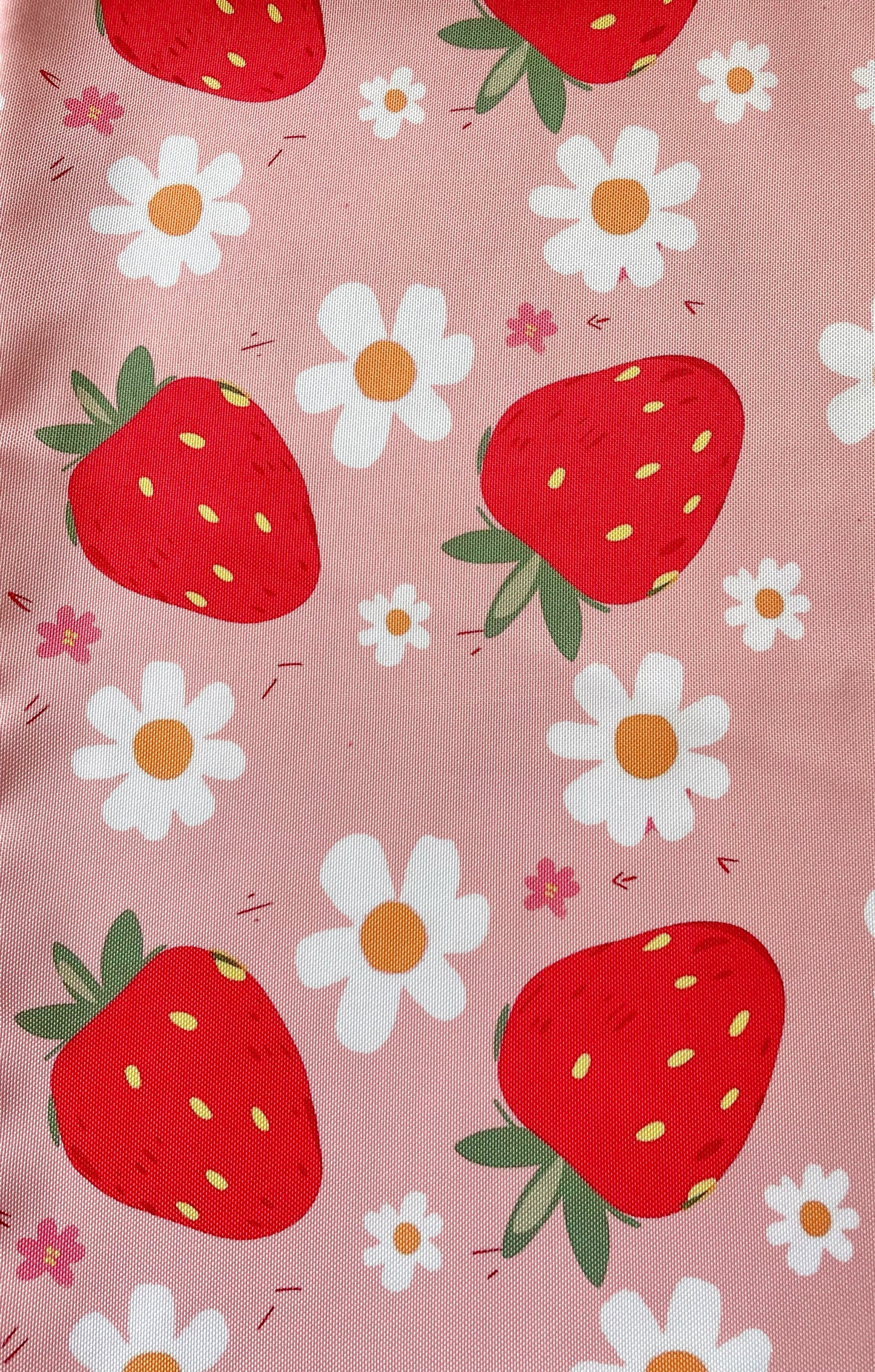 Pattern of strawberries and daisies on a pink background